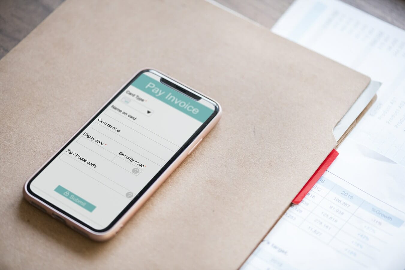 A smartphone with a form on it sitting on top of a desk, illustrating termination payments.