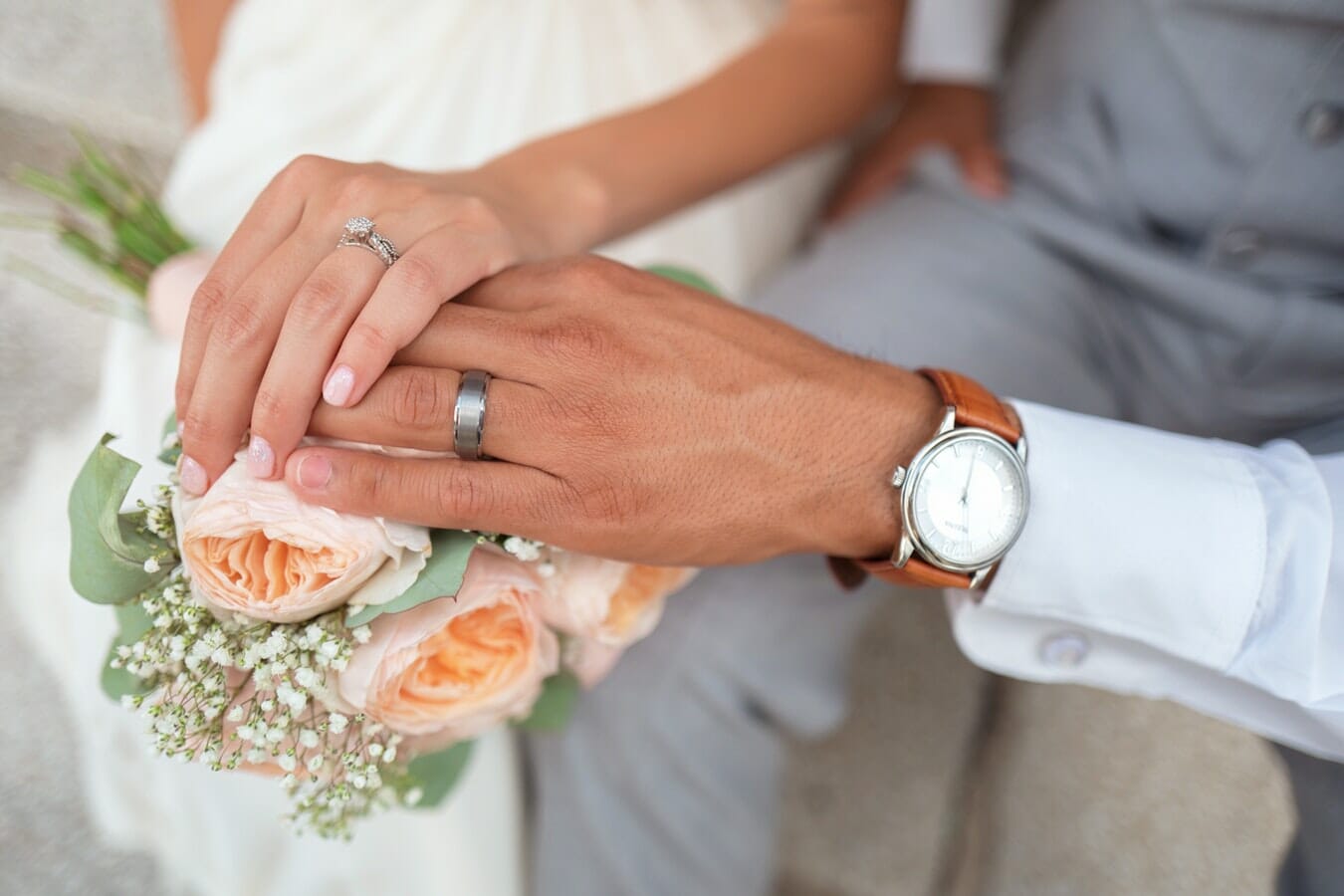 A couple showcasing their wedding rings during the Marriage Allowance ceremony.