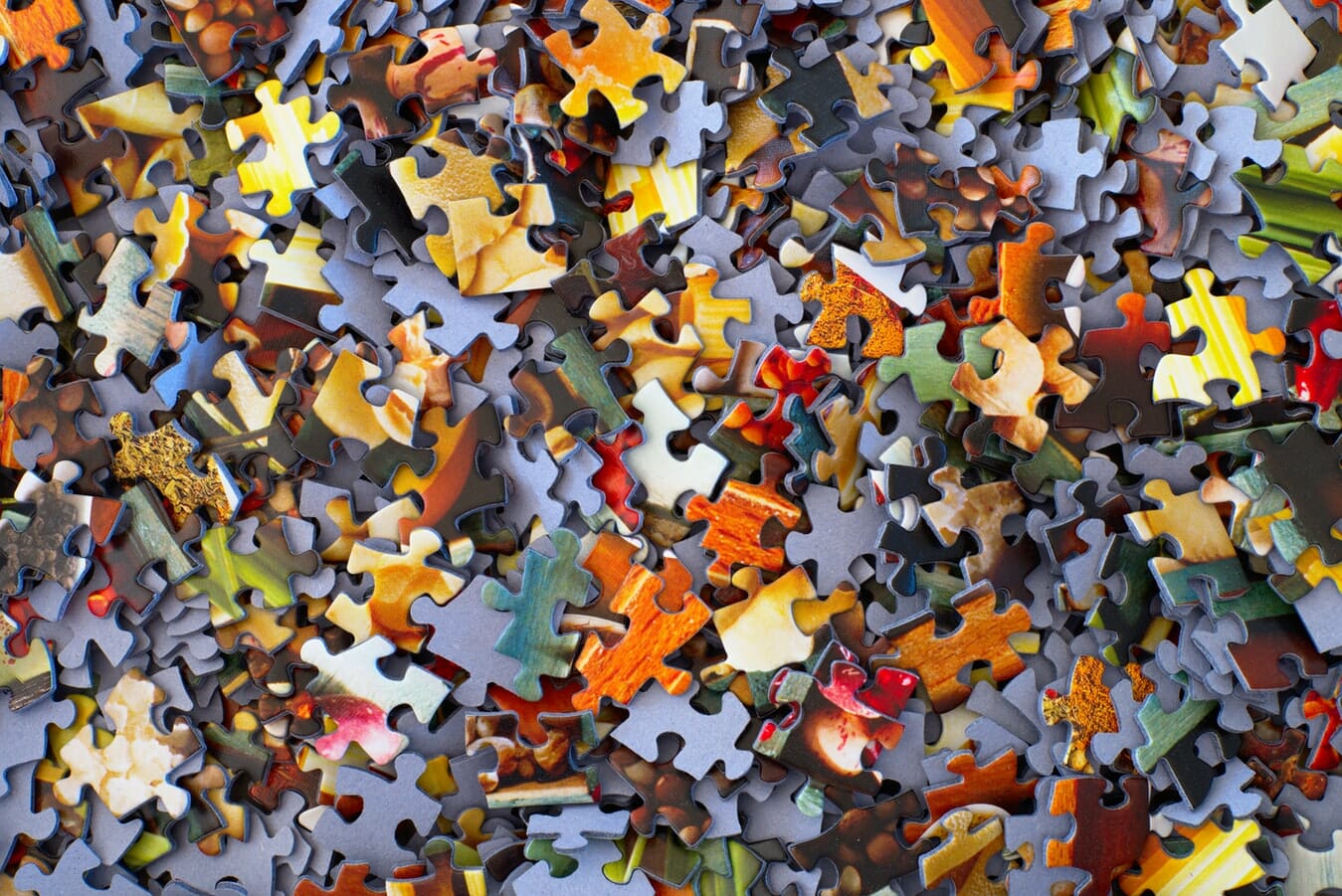 A close up of a pile of puzzle pieces.