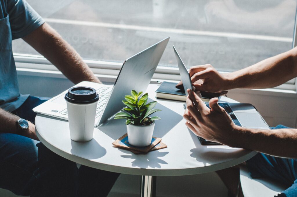 Two people working at laptops 