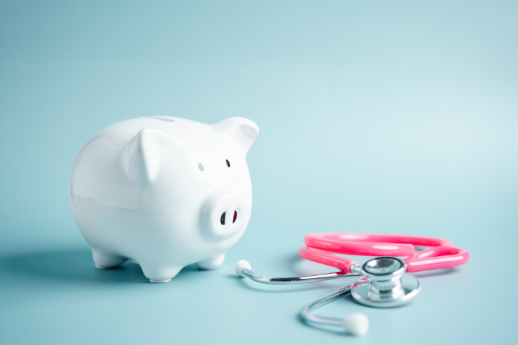 A piggy bank accompanied by a stethoscope, representing financial health or the cost of healthcare.